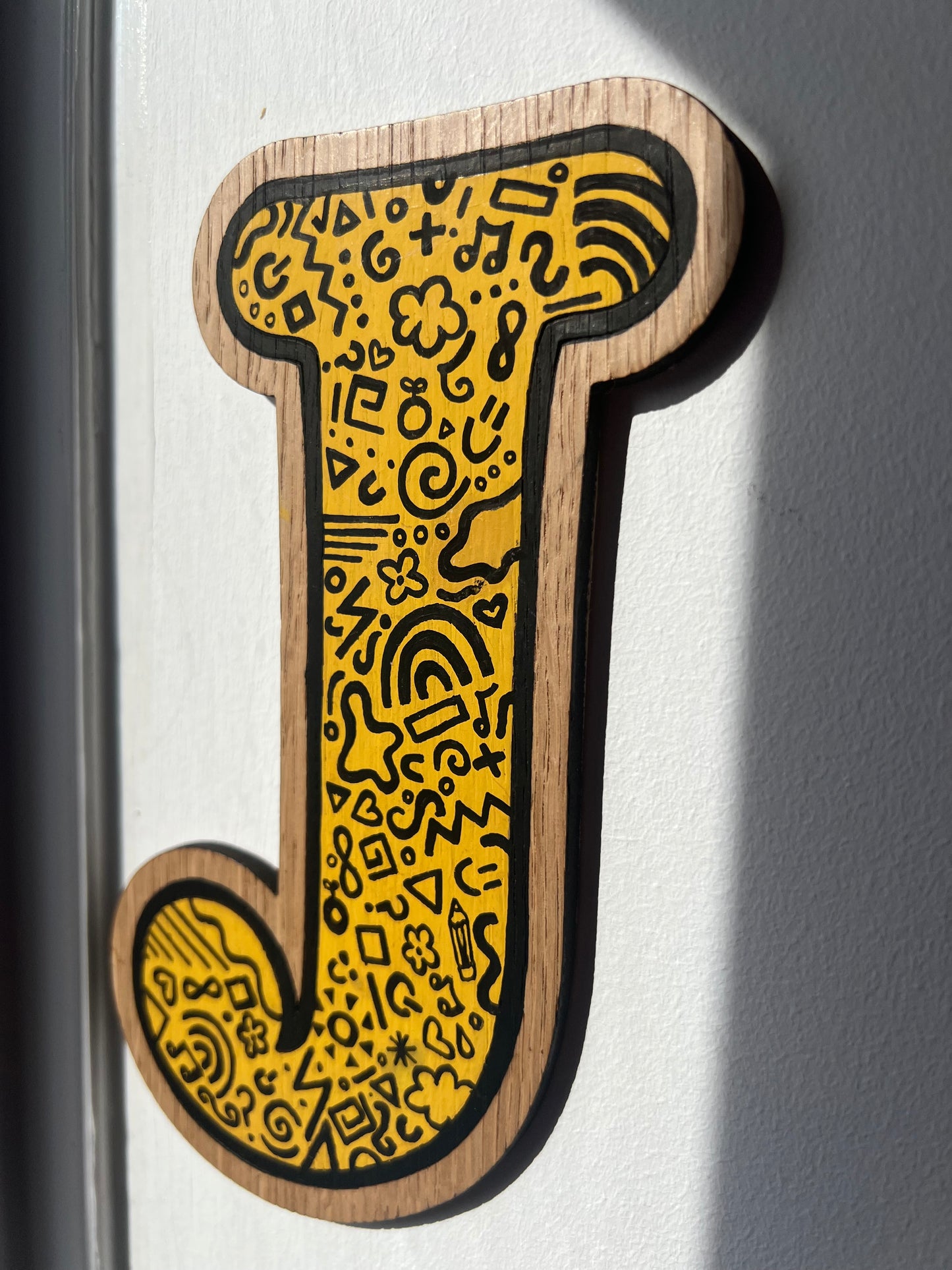 Yellow and black initial-doodle pattern