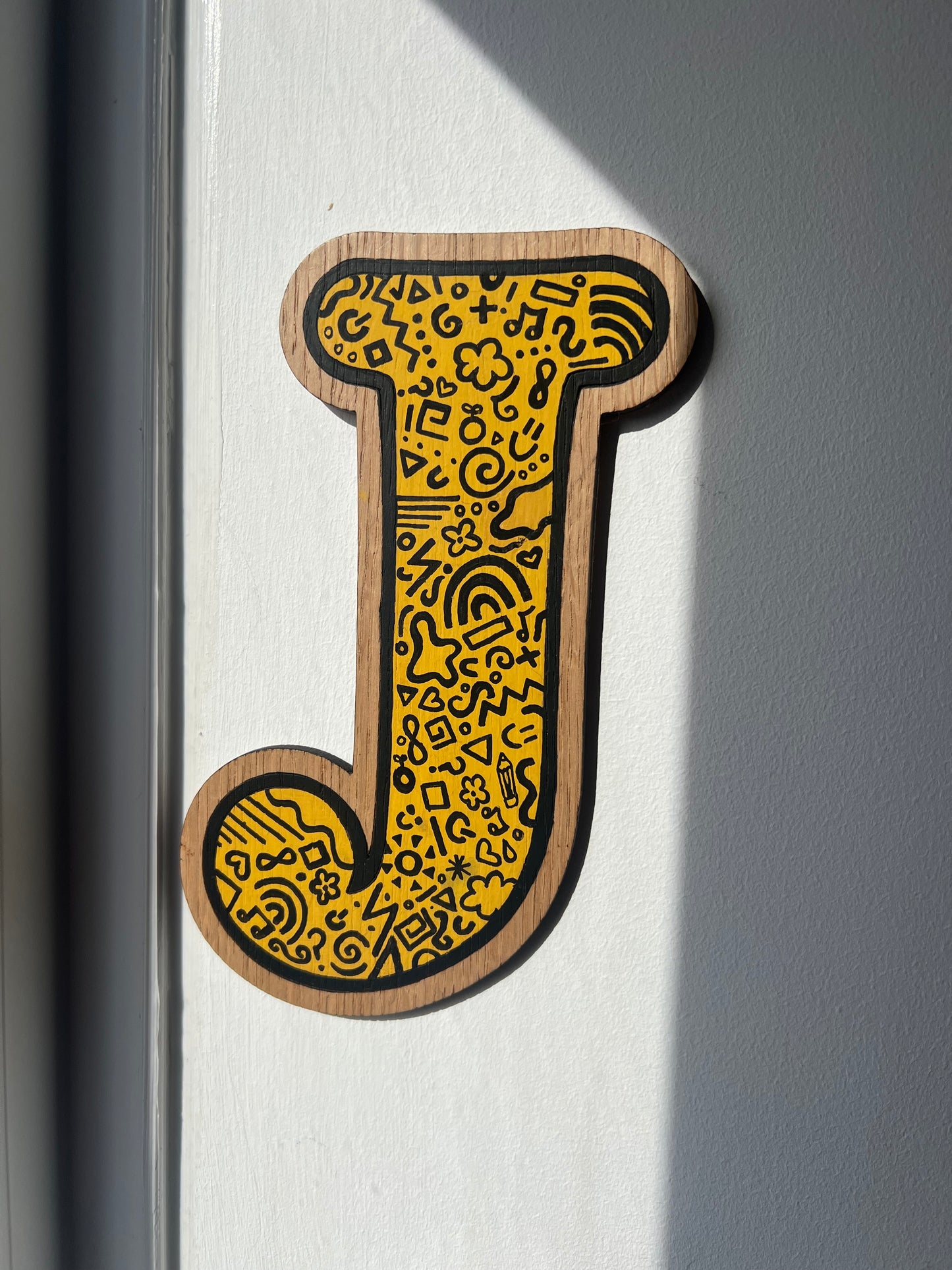 Yellow and black initial-doodle pattern