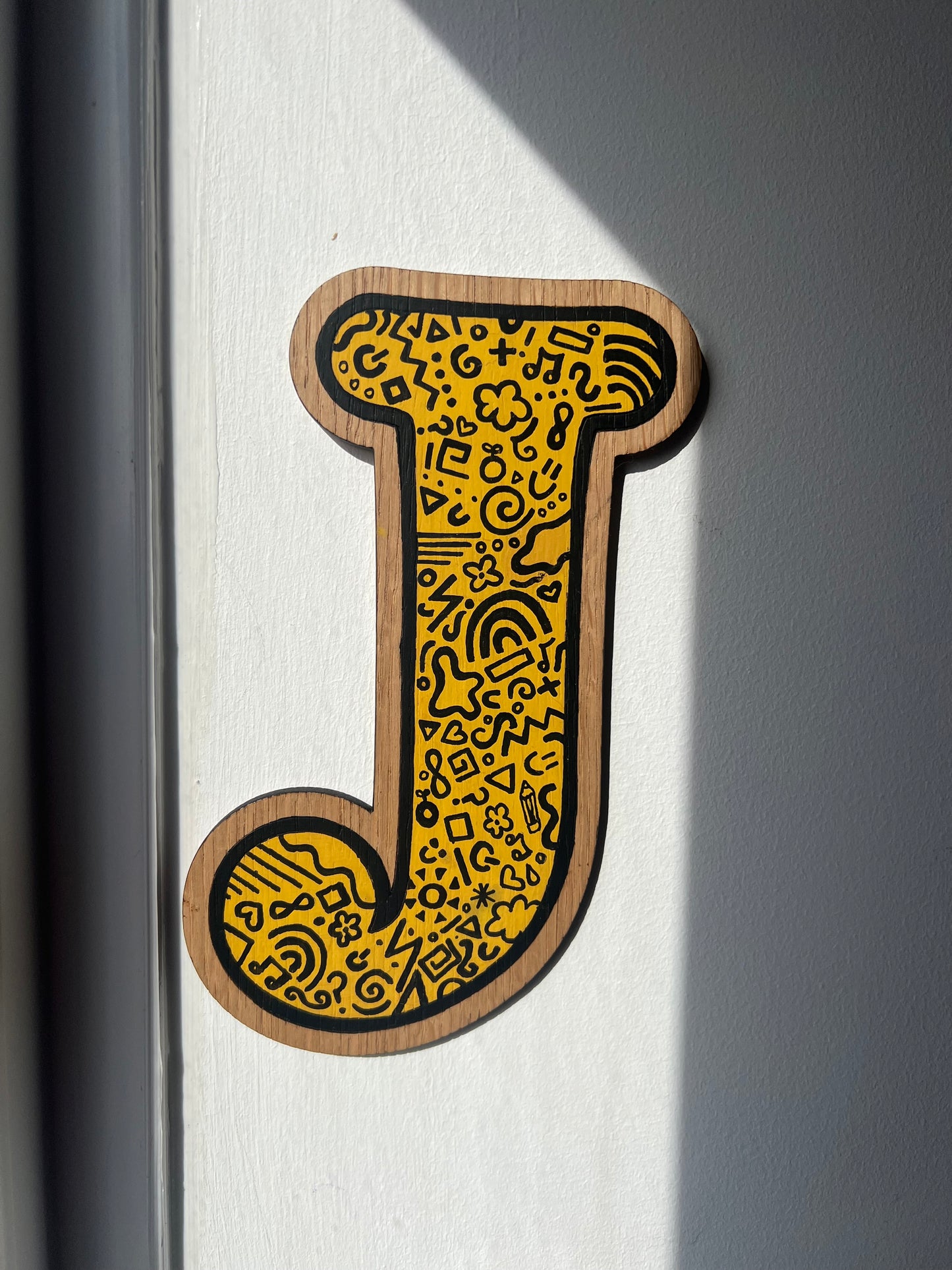 Yellow and black initial-doodle pattern