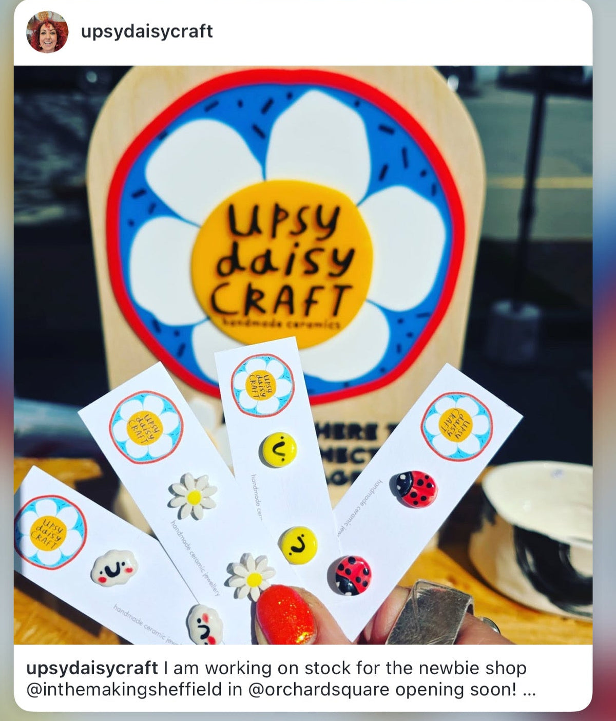 Upsy Daisy Craft branding with stickers and a wooden sign.